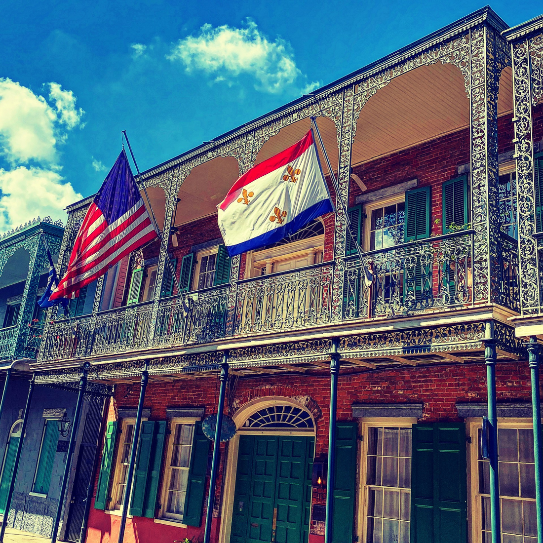 U.S. and New Orleans flags on a French Quarter balcony