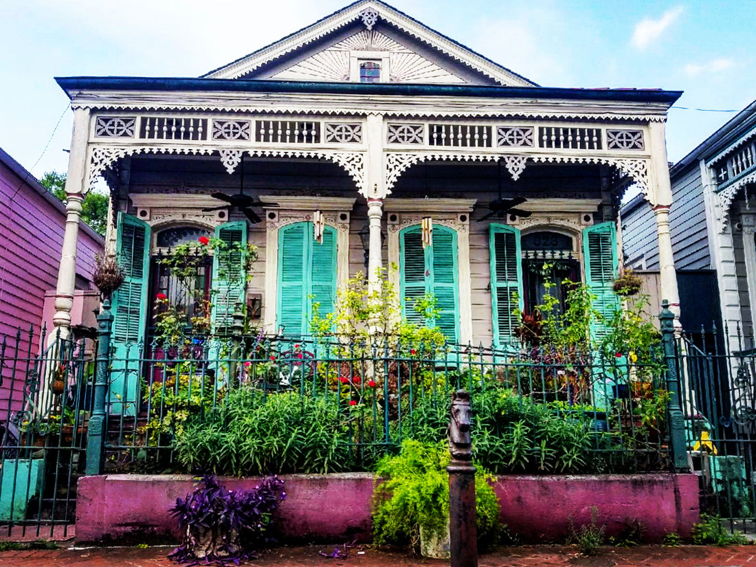 New Orleans shotgun house with turquoise shutters