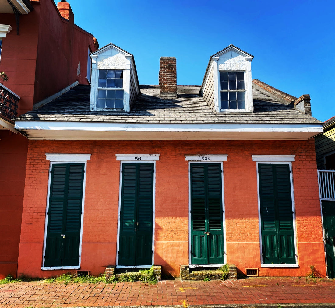 Orange Creole cottage with green shutters